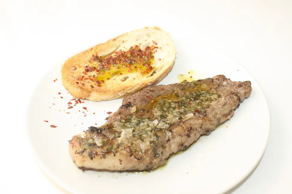 Filete a la plancha con aliño de hierbas y una tostada con aceite y guindilla, en A’rocha